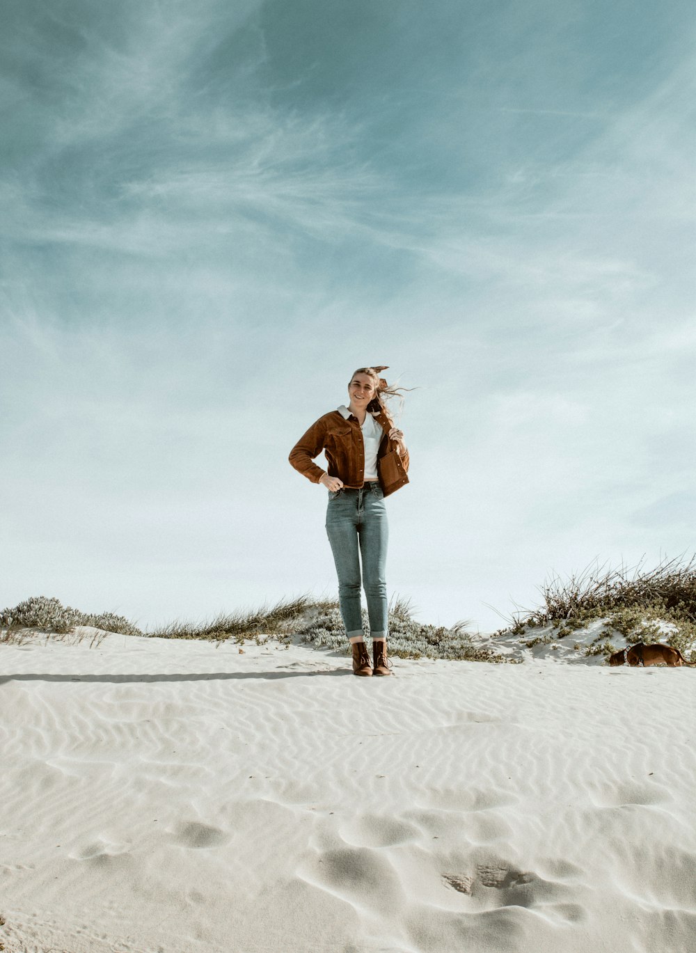 woman in brown coat standing on focus photography