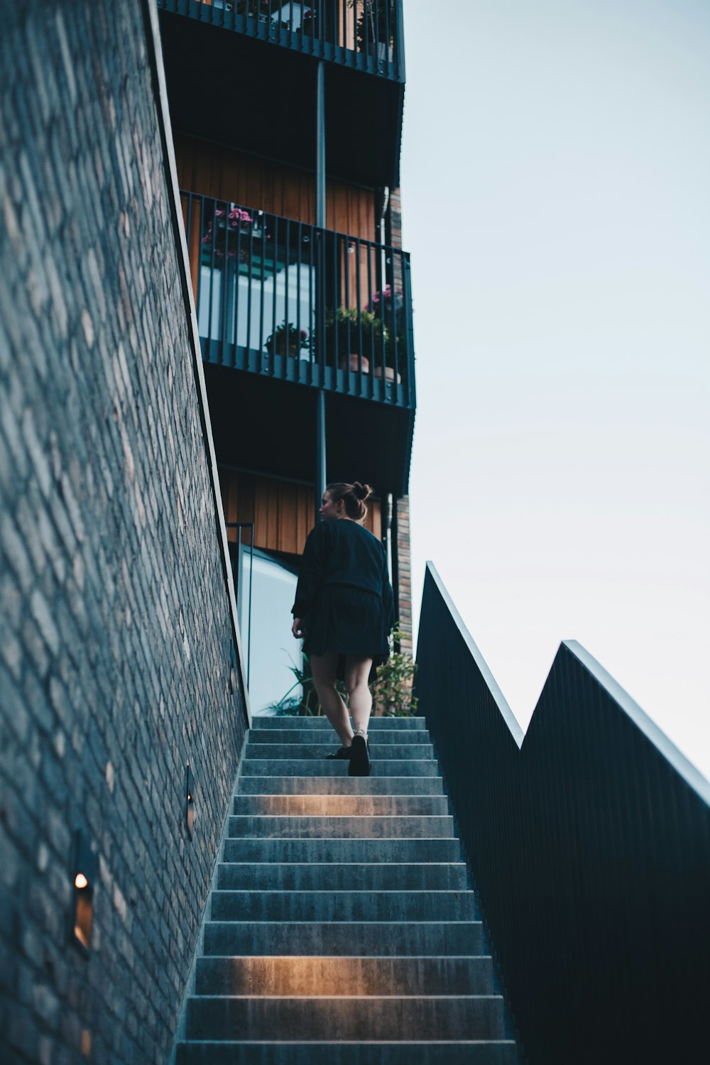 woman walking and going up on building