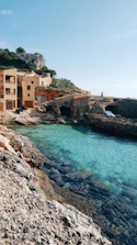 a body of water next to a rocky shore spain