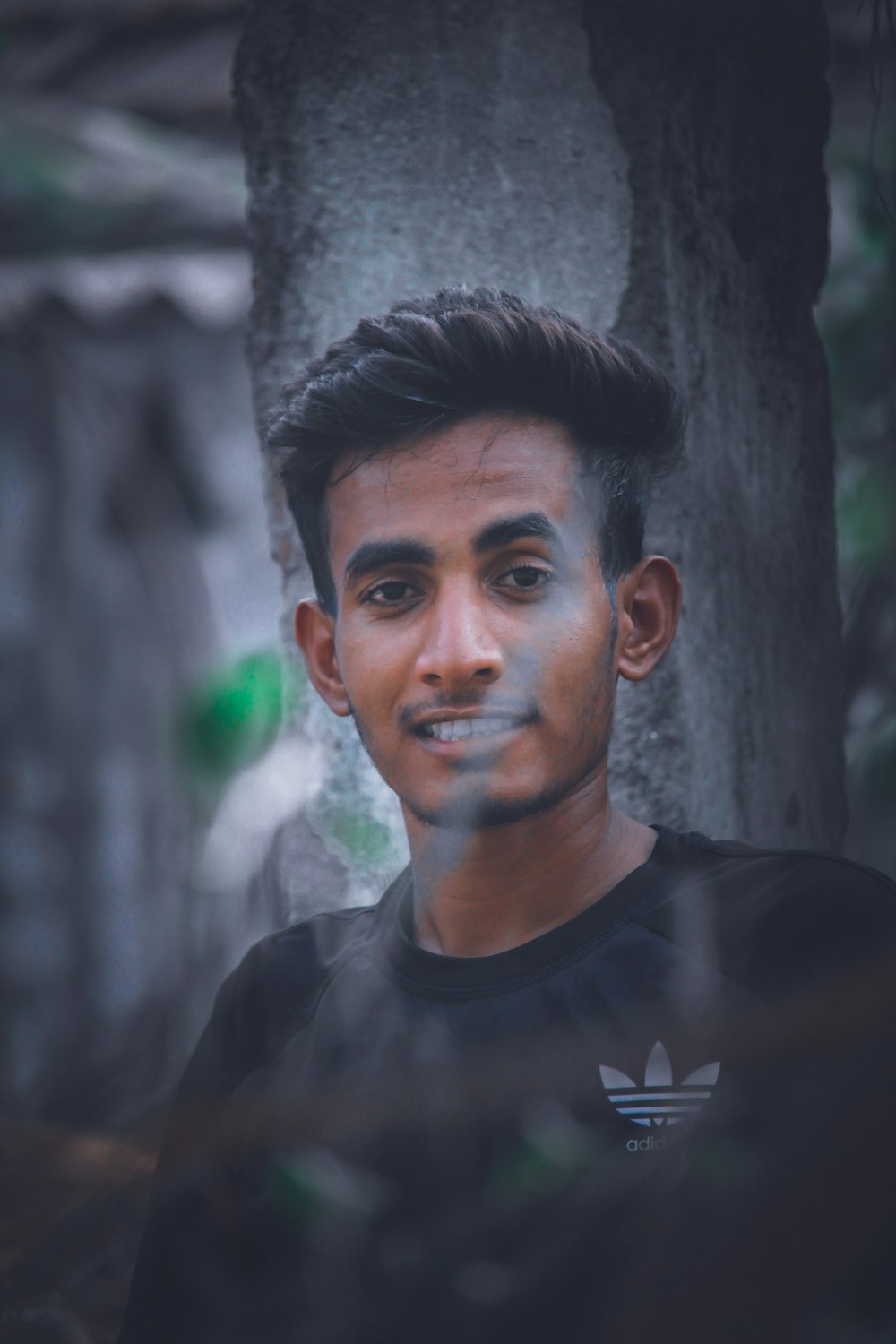 smiling man wearing black Adidas shirt