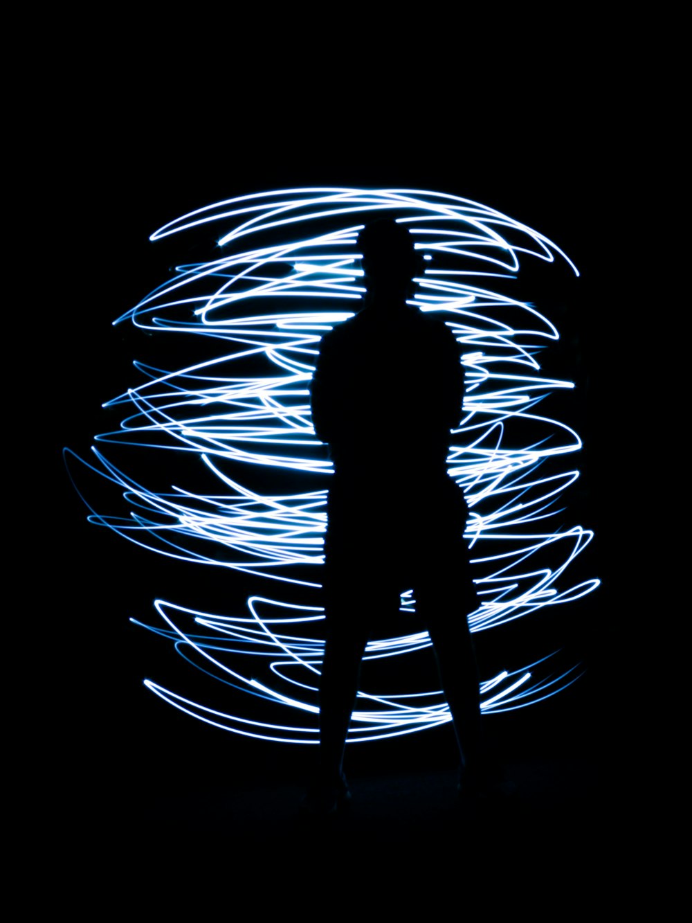 black silhouette of a man with overexposed lights
