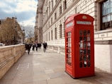 red telephone booth near building