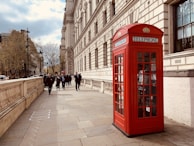 red telephone booth near building