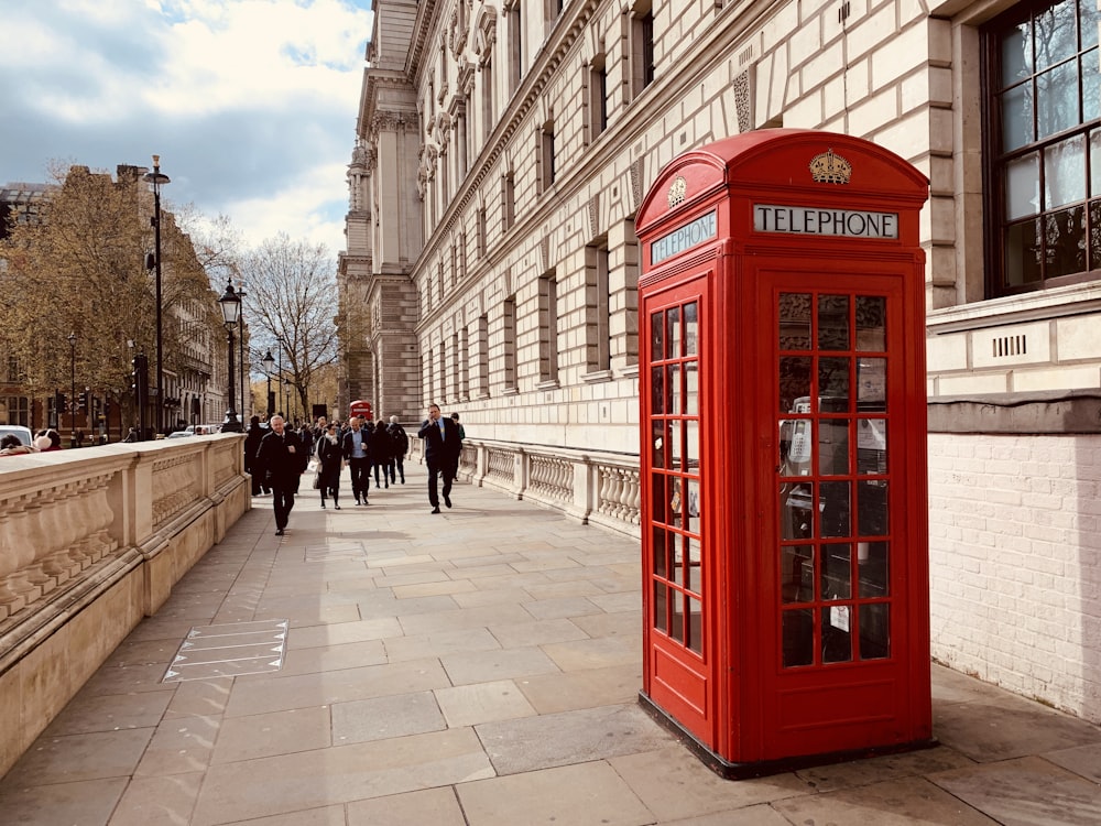 red telephone booth near building