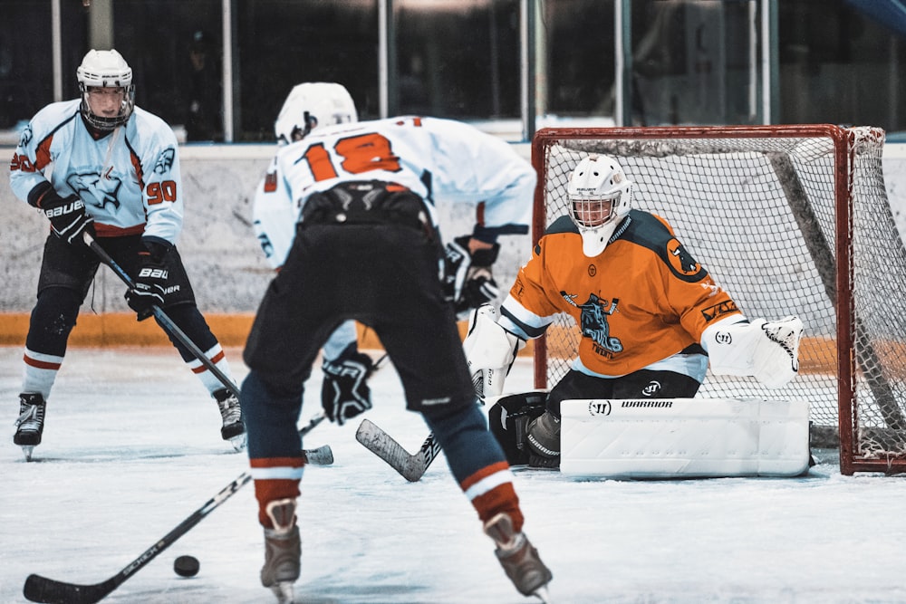 group of men playing ice hockey