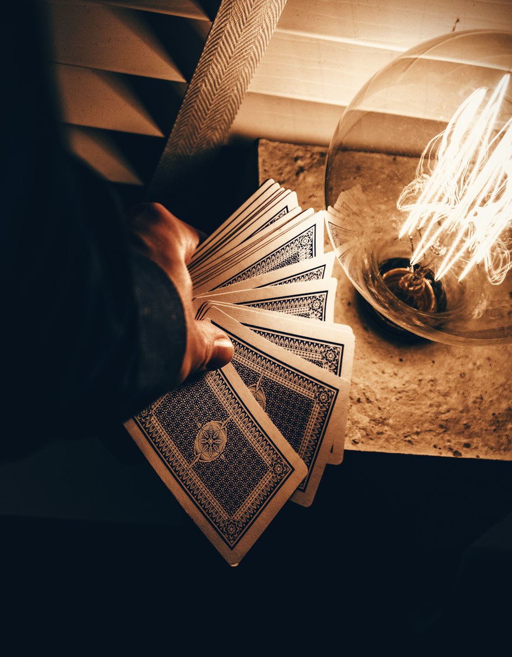 person holding blue deck cards
