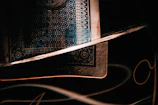 Mystical rendering of the card with shimmering shadows and elegant lines.