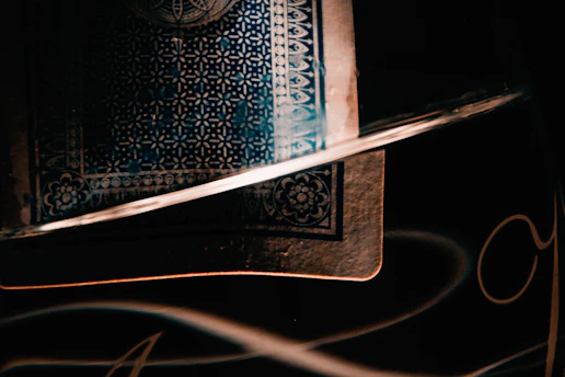 A richly detailed King of Pentacles tarot card glowing softly against a dark, mystical background.