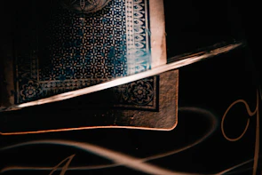 Close-up of The Devil card’s detailed artwork highlighting the entwined figures and dark ambiance.
