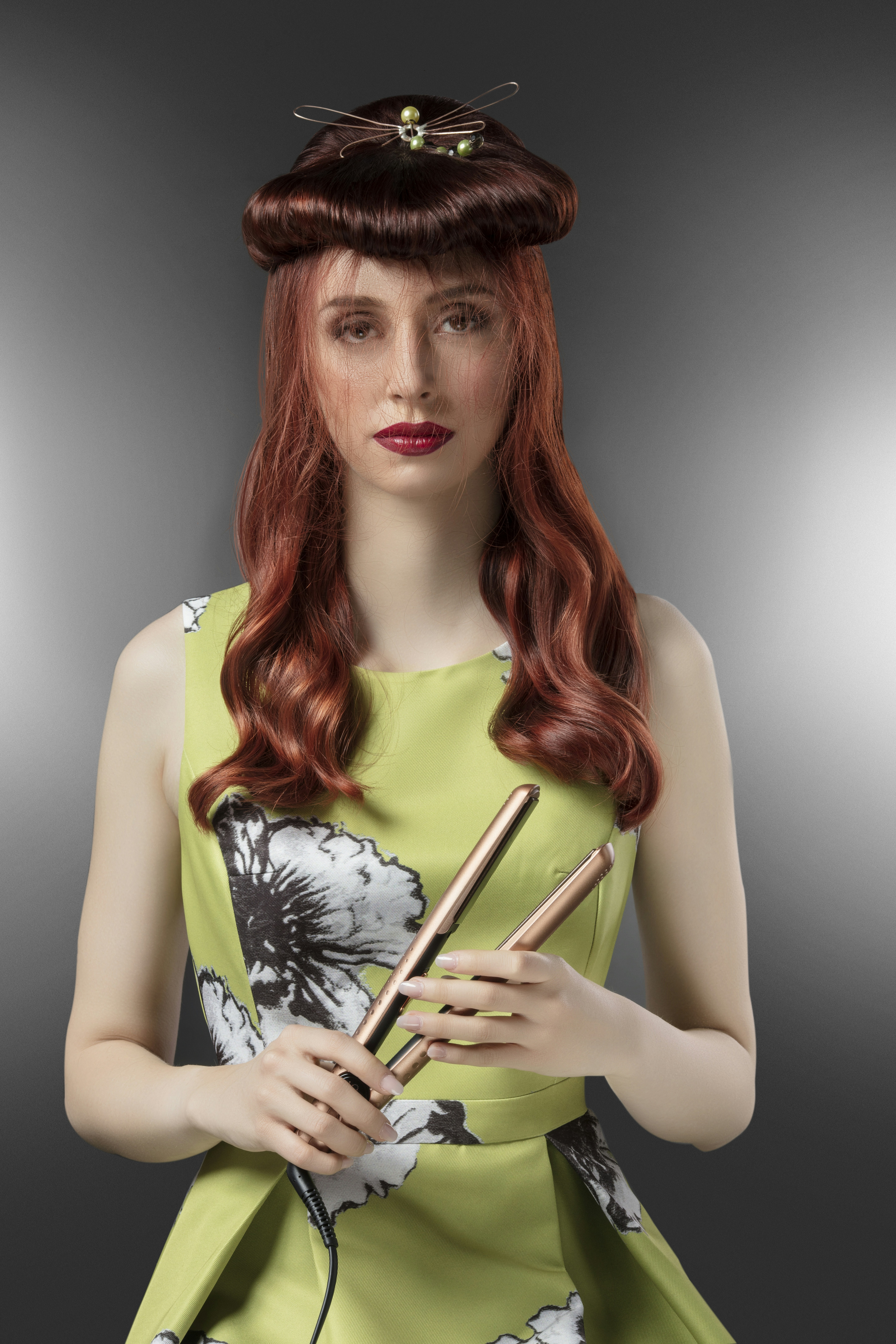 woman holding hair curling iron