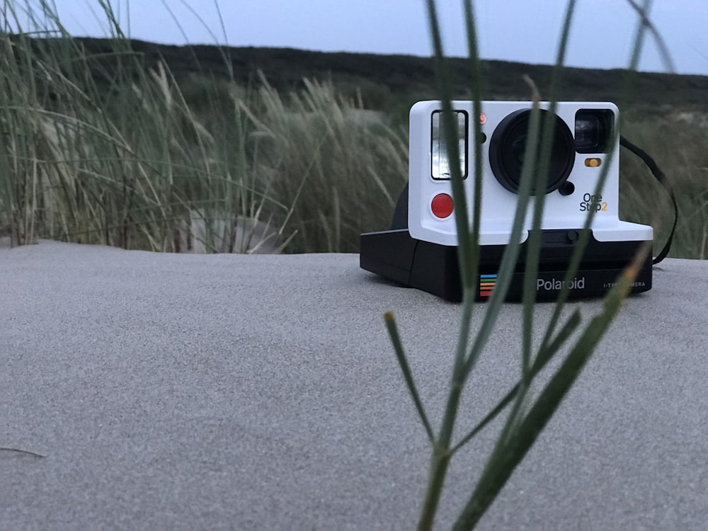 white and black Polaroid instant camera