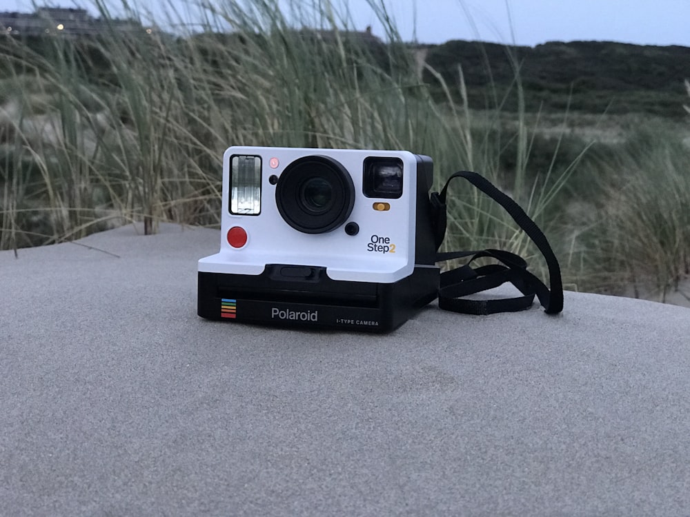 white and black Polaroid One Step 2 instant camera