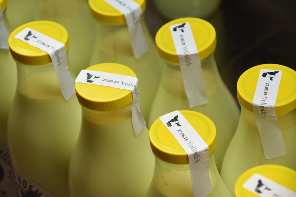 milk bottles with yellow caps sealed with white tapes