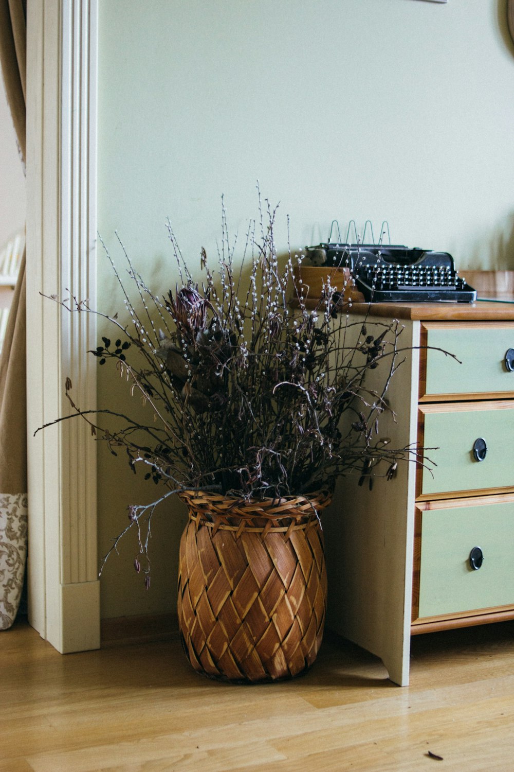 brown planter near dresser