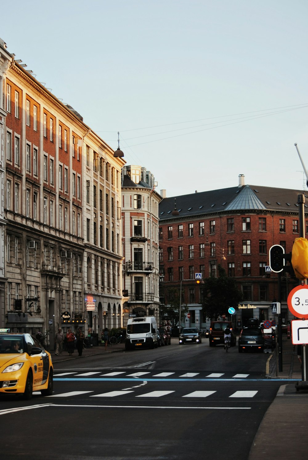 white concrete building beside yellow vehicle during daytime