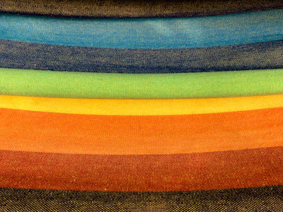 Stack of finished products showcasing a gradient of screen print designs.