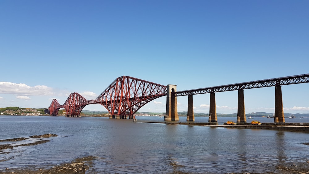 red cable bridge under clear blue sky