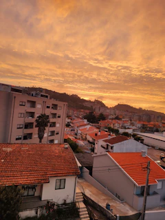 A peaceful sunset view over a completed Sampadha Properties residential area, with tree-lined streets and modern homes.