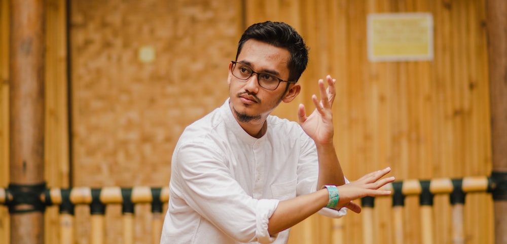 man in white shirt doing martial arts moves