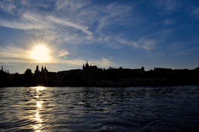 A breathtaking view of Lisbon’s sunset sky reflected on the calm waters of the Tagus River.