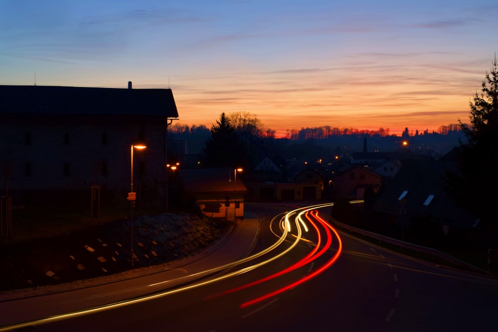 road between houses in timelapse photo