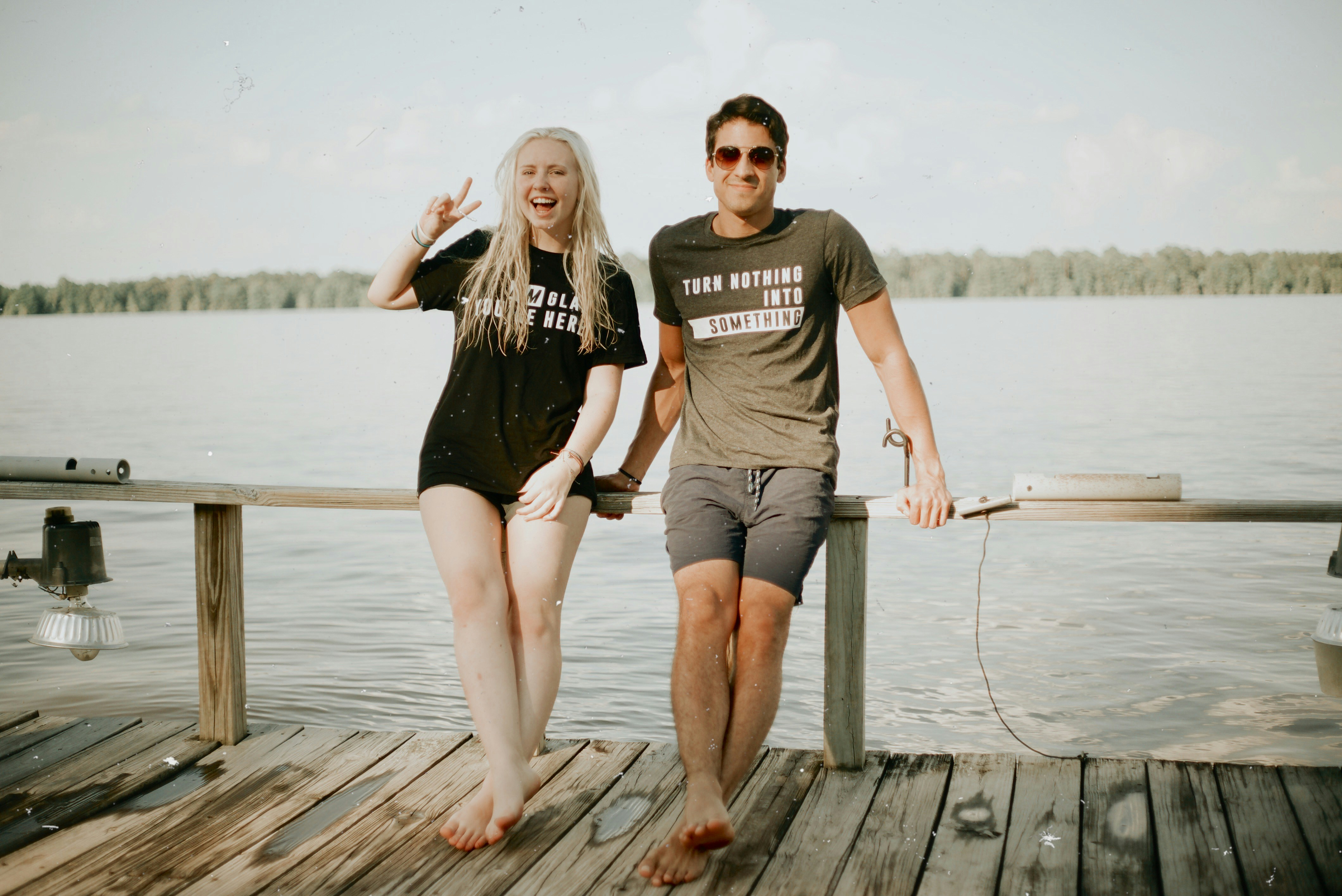 man and woman near calm ocean