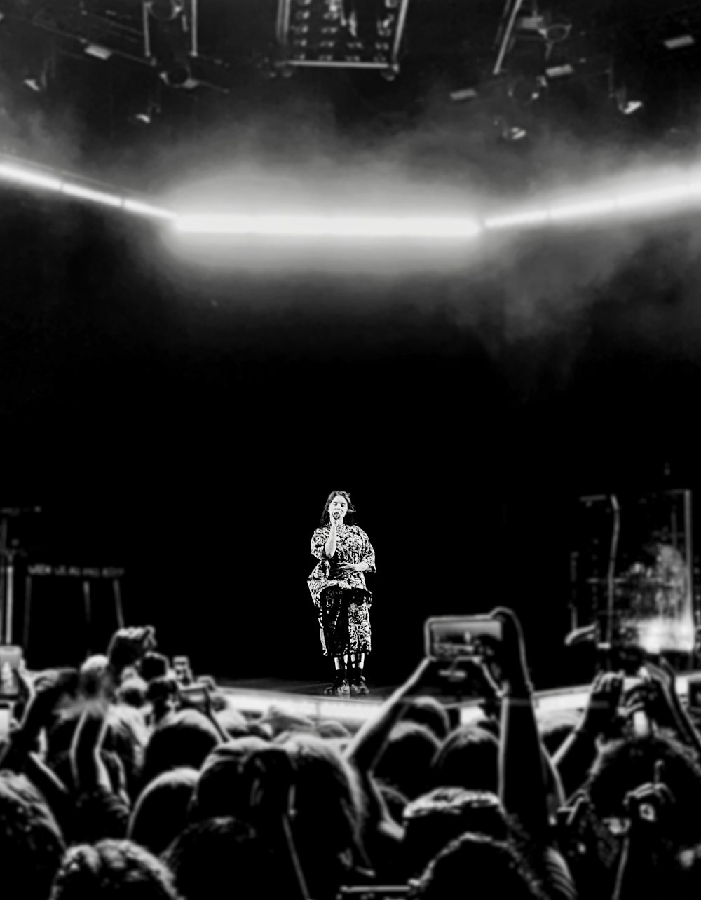 greyscale photography of person performing on stage