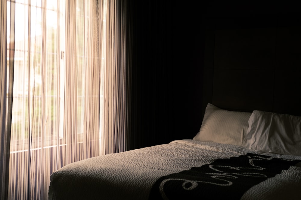 bed near window with curtain