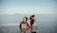 Smiling tourist couple in casual clothes enjoying scenic view from Mount Bromo.