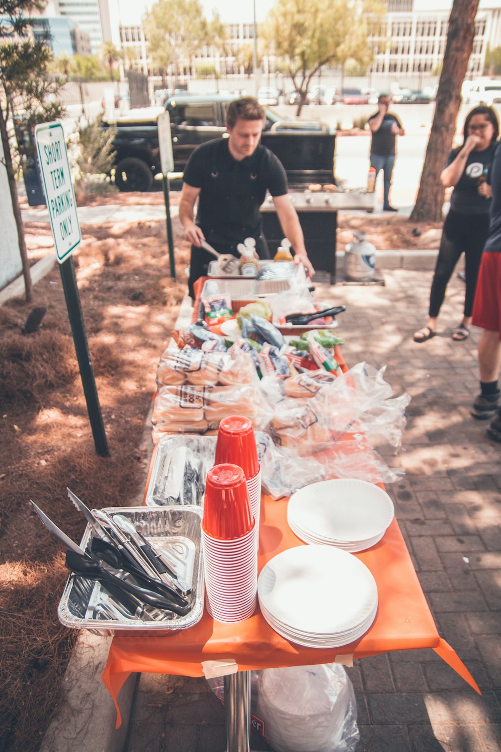 people preparing food outside during daytime