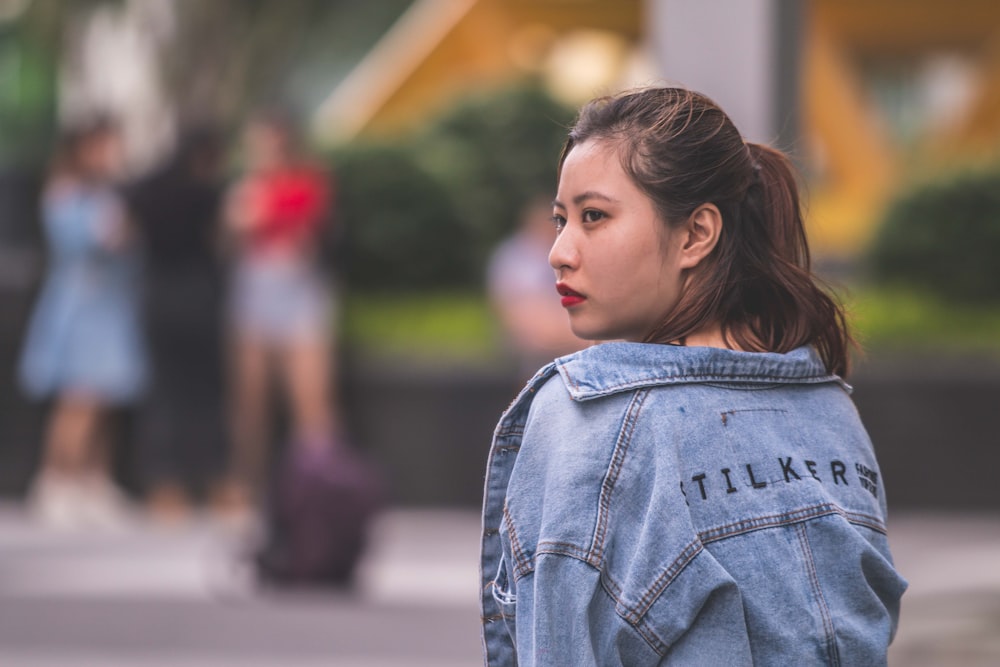 woman wearing blue denim jacket focus photography