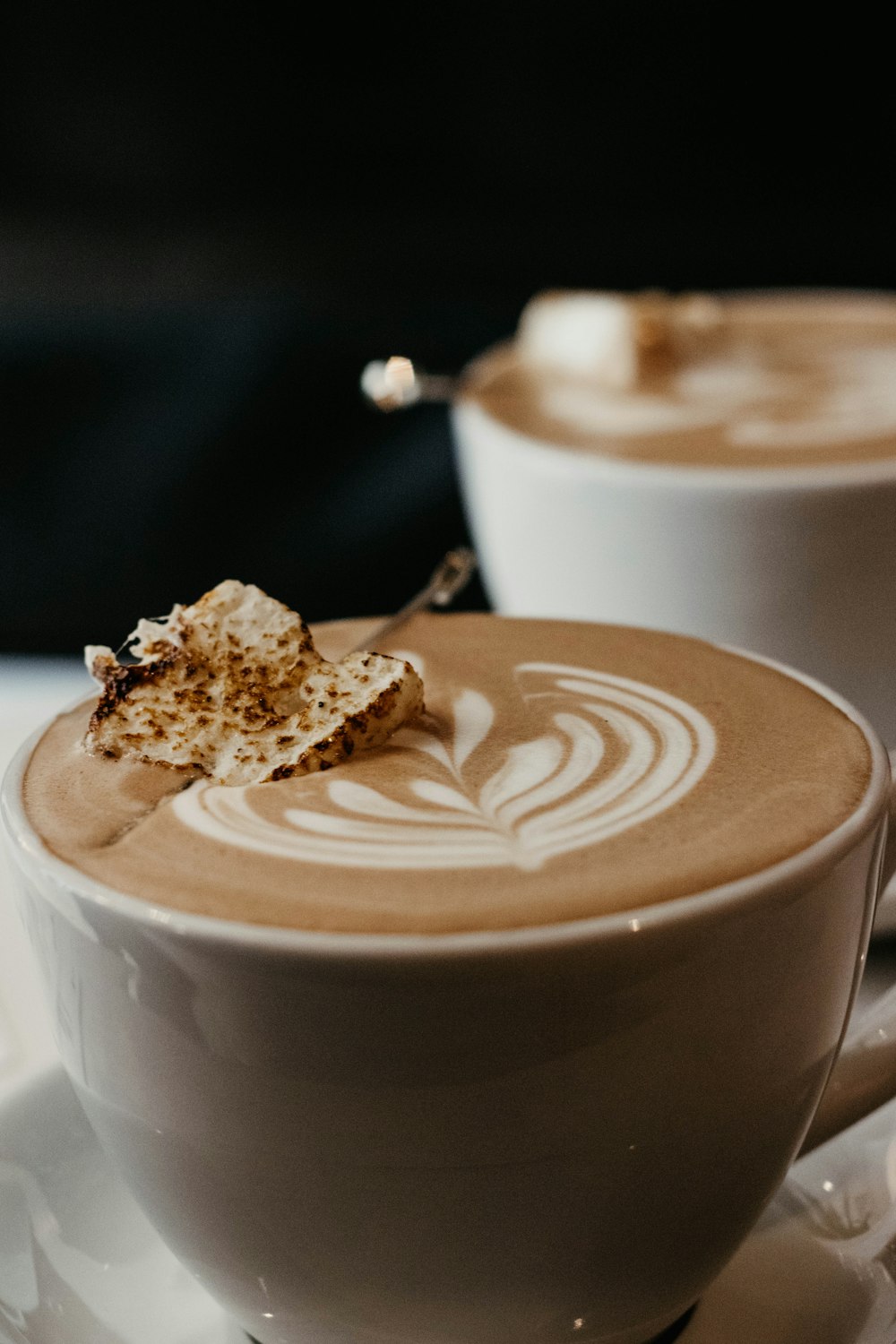 white ceramic mug with cappuccino