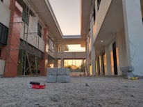 Workers carefully inspecting blocks on a construction site during golden hour.