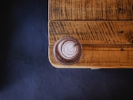 A beautifully crafted latte art on a wooden table.