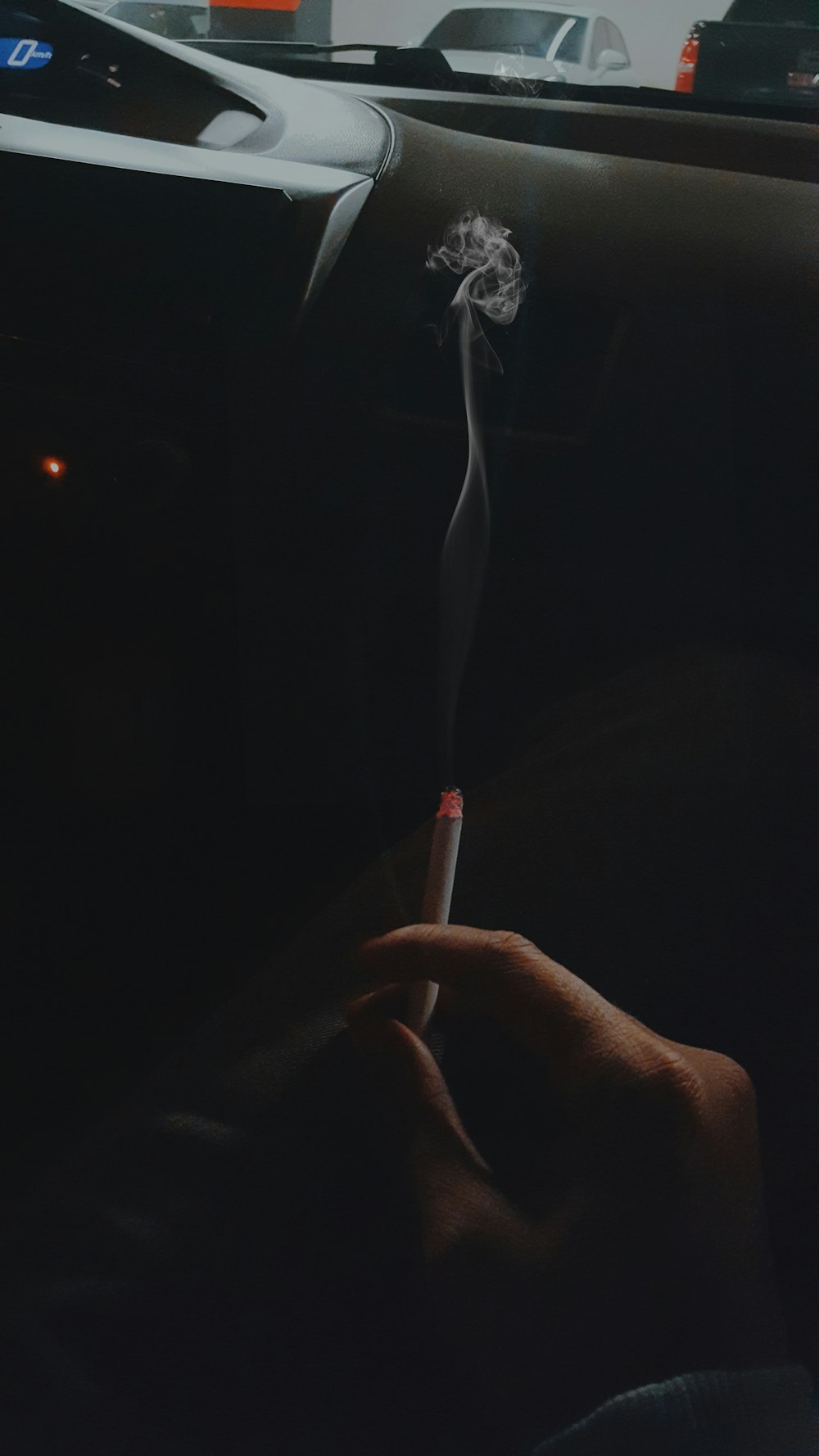 person holding a cigarette close-up photography