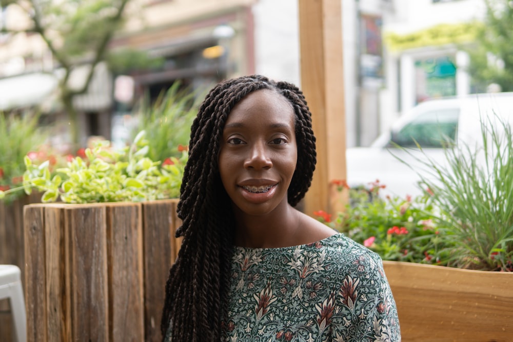 smiling woman wearing grey floral top