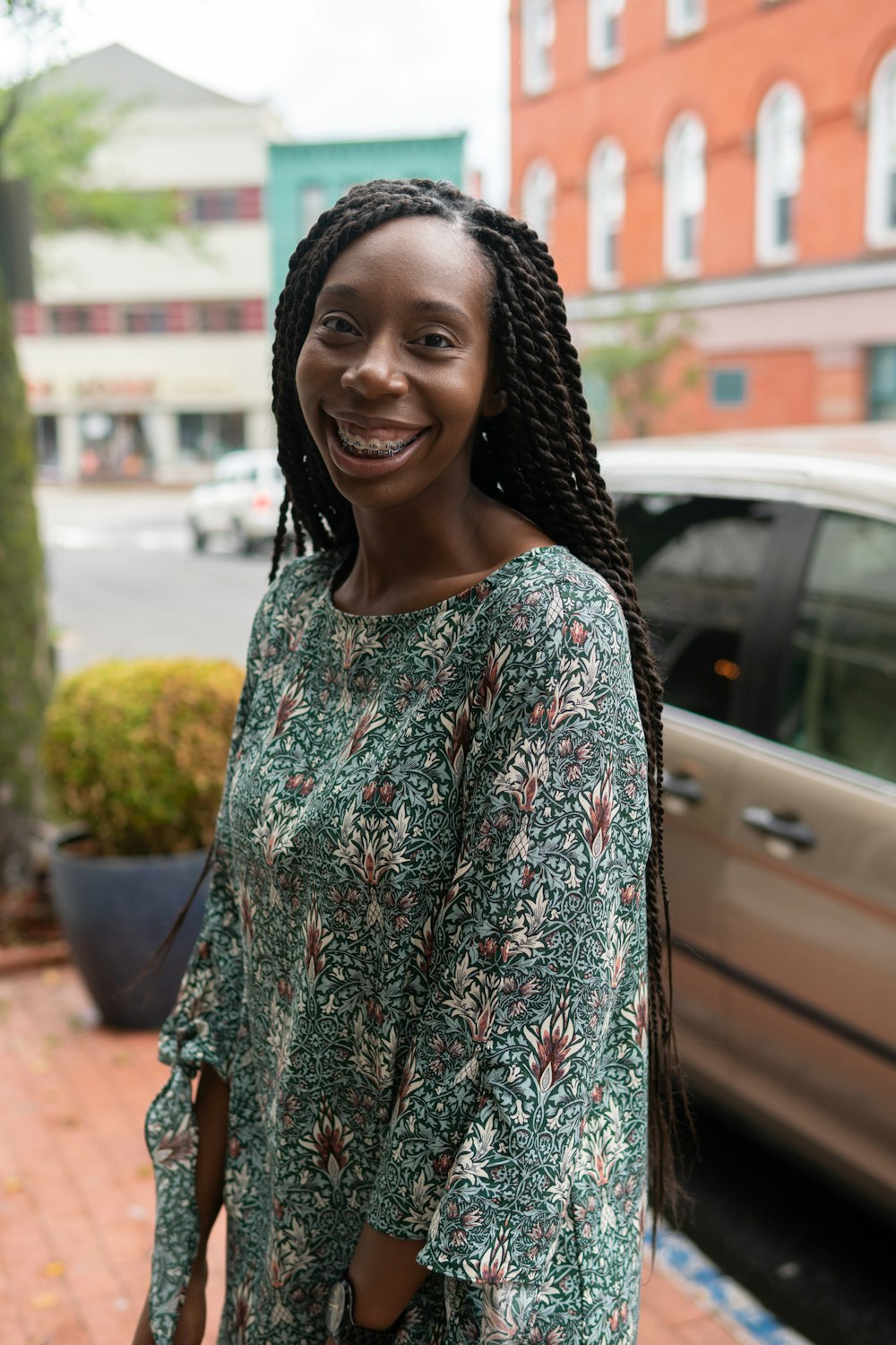 smiling woman near parked car