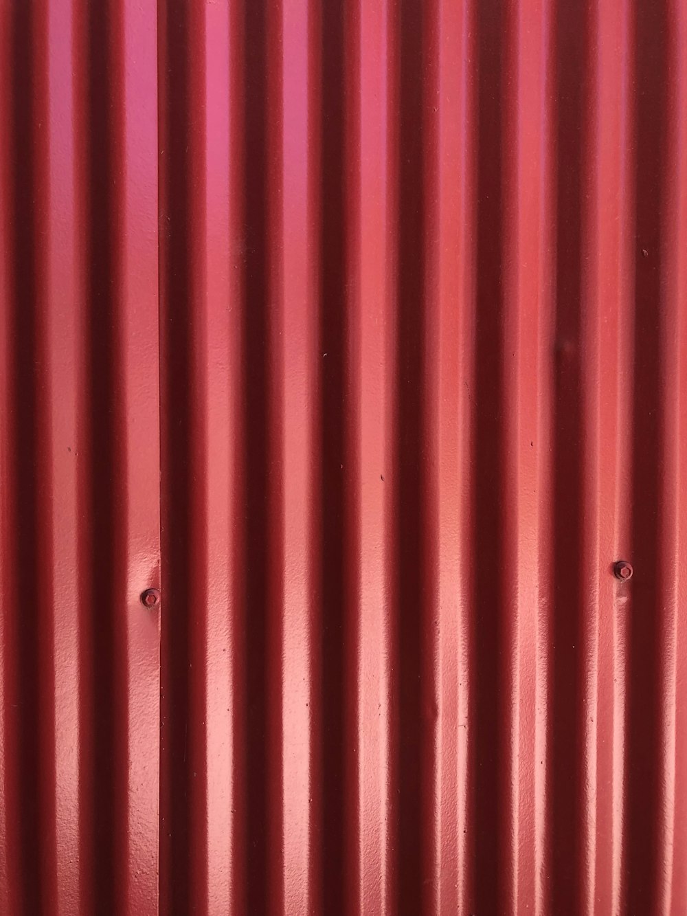 a close up of a red metal wall
