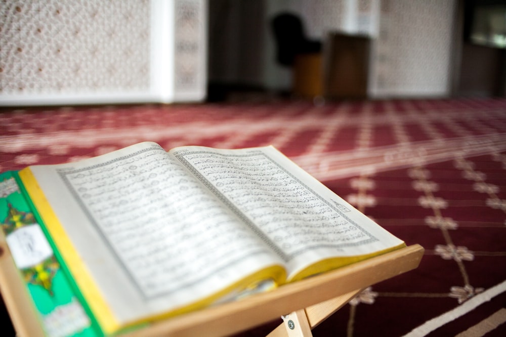 an open book sitting on top of a wooden table