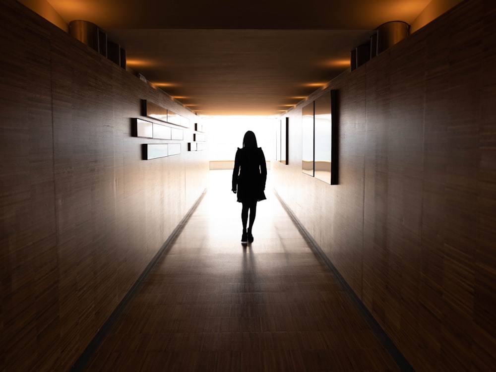 silhouette of woman near wall