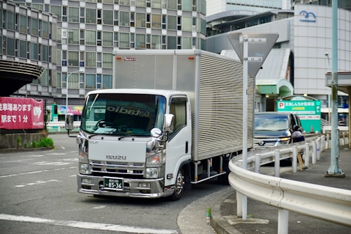 A BRB Log Transportes truck navigating through urban streets during delivery.
