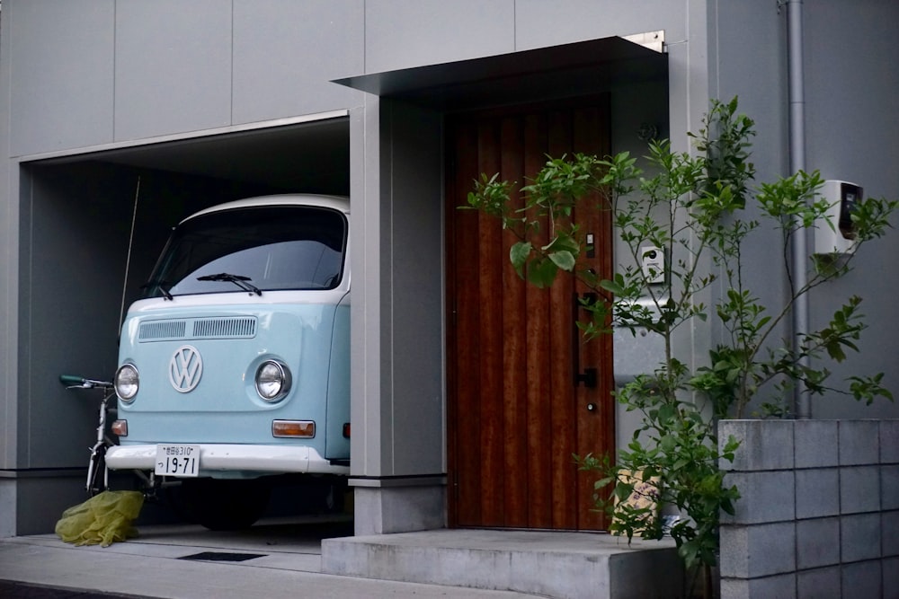 teal Volkswagen van parking on garage