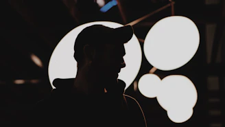 silhouette of man wearing fitted cap