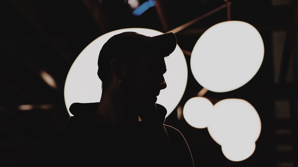 silhouette of man wearing fitted cap