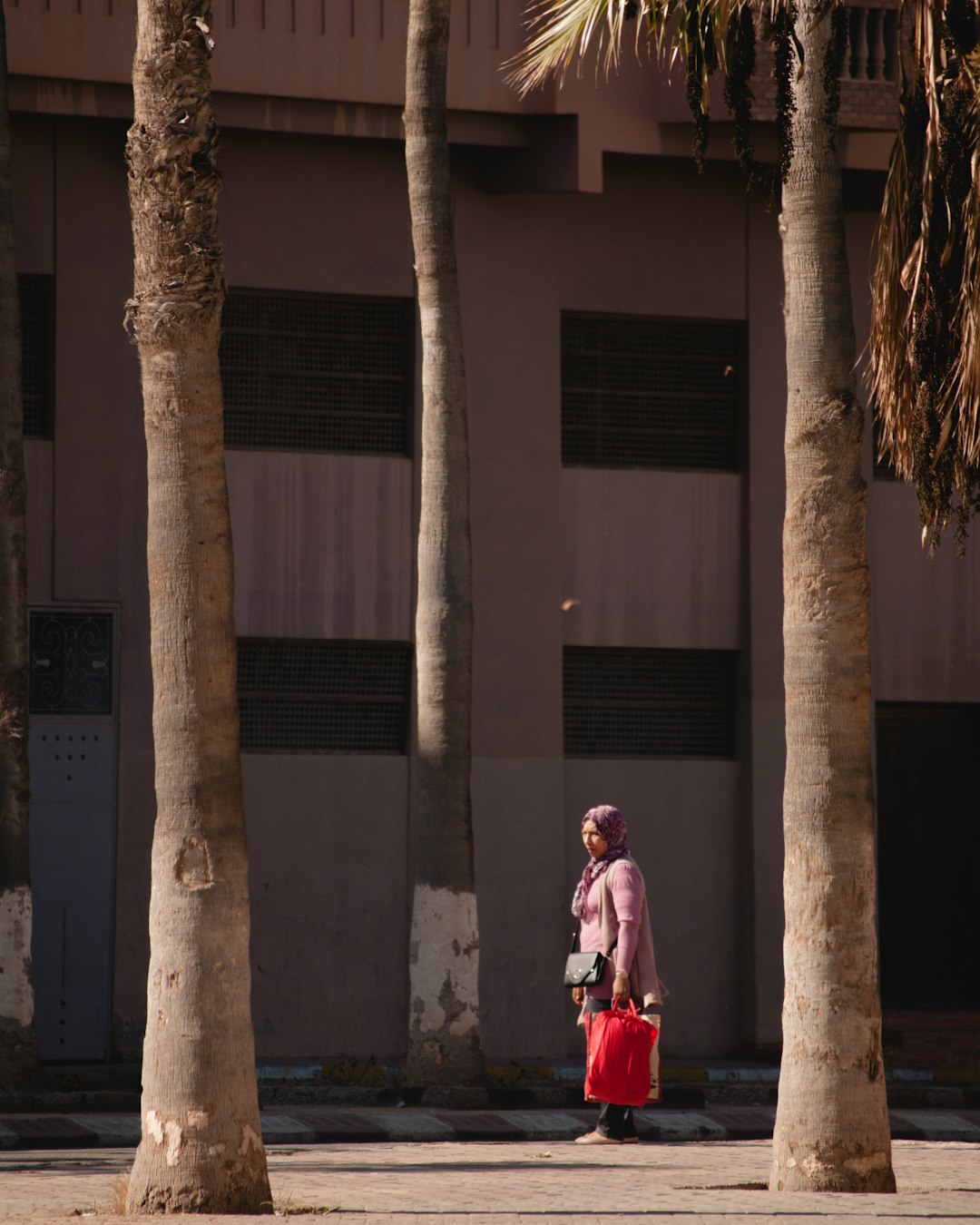 woman standing beside building