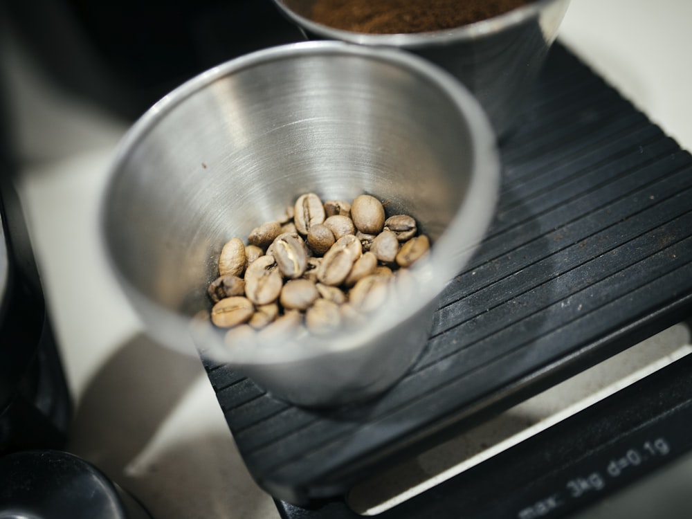 coffee beans in gray stainless steel cup
