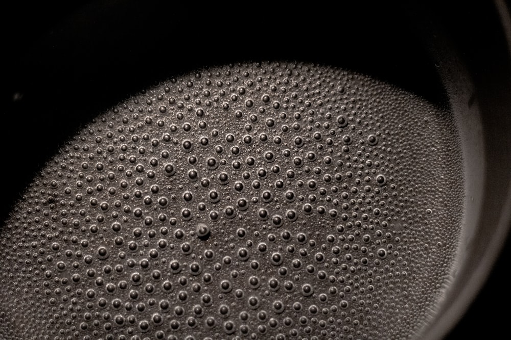 a close up of a pot with a black background