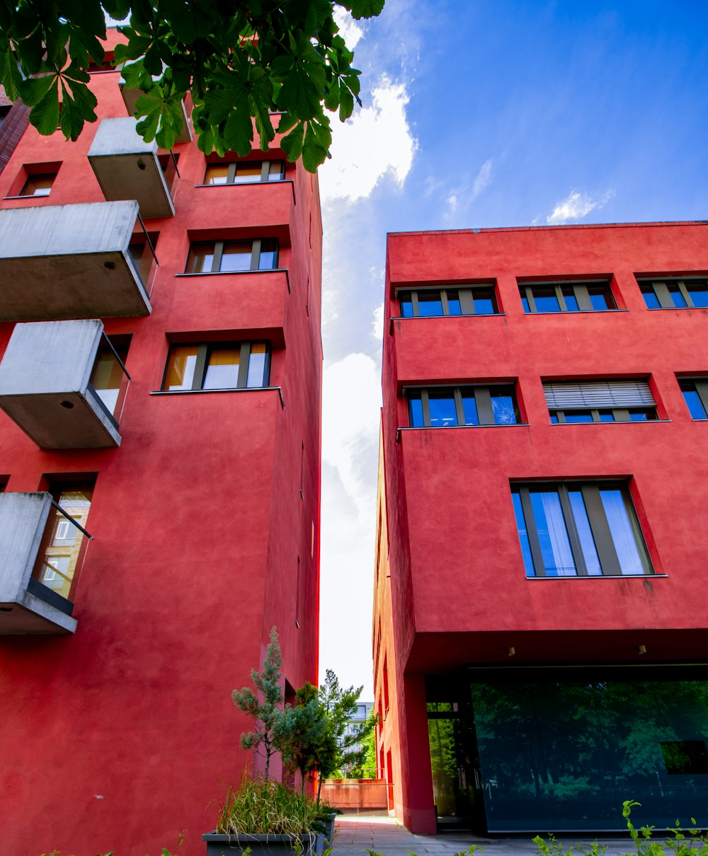 low-angle photography of two red buildings