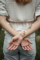 person with her arms crossed on her back