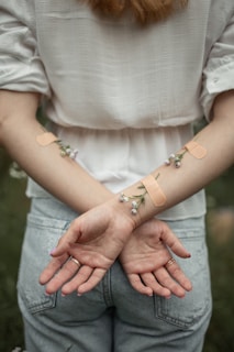 person with her arms crossed on her back